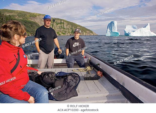 Tourist viewing an iceberg stranded in the harbour of Old Bonaventure, Bonavista Peninsula, Trinity Bay, Discovery Trail, Newfoundland & Labrador, Canada