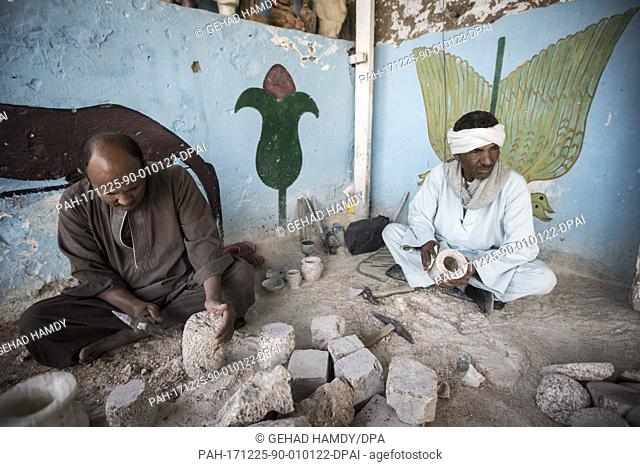 A photo made available on 26 December 2017, shows craftsmen carving Alabaster pots at a local factory, in Gurna village, Luxor, Upper Egypt, 09 December 2017