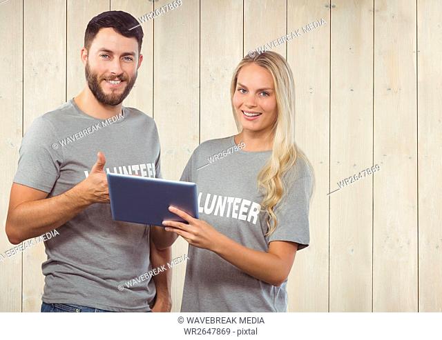 Volunteer couple using digital tablet and showing thumbs up