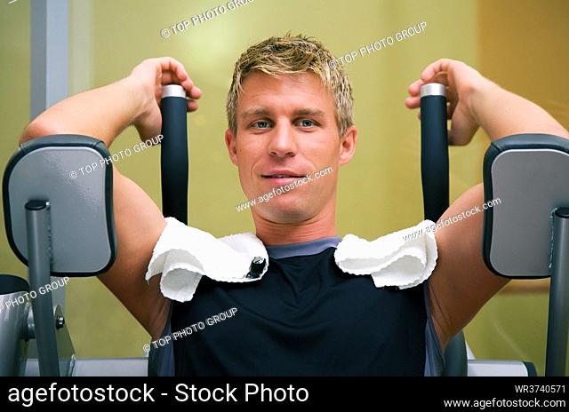 Man working out in the Gym on a machine