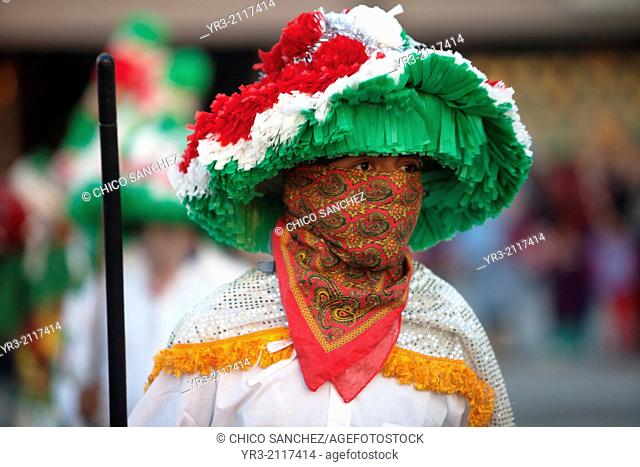 A dancer from Chocaman, Veracruz, holding a club, dances the Danza de los Santiagos at the pilgrimage to Our Lady of Guadalupe Basilica in Mexico City, Mexico