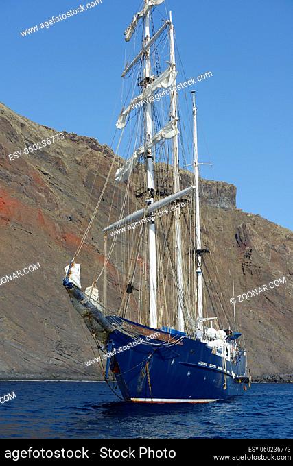 Mary Anne at anchor in front of cliffs, Punta Vicente Roca, Isabela Island, Galapagos Islands, Ecuador