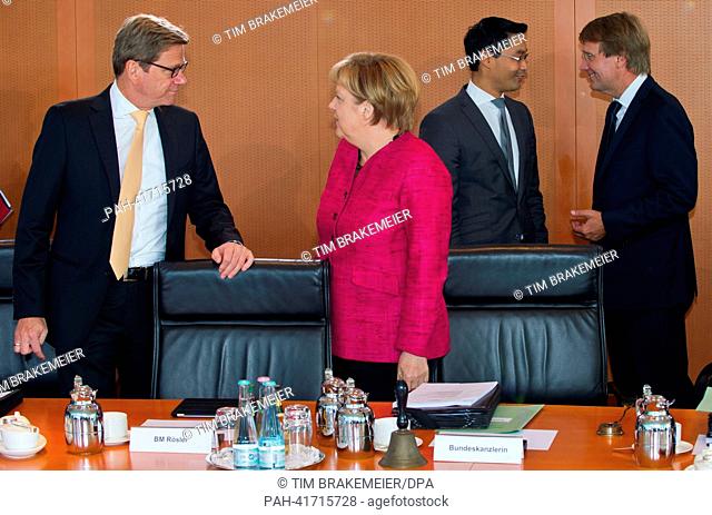 German Foreign Minister Guido Westerwelle (L-R) and Chancellor Angela Merkel talk whileGerman Economics Minister Philipp Roesler and Chief of Staff...