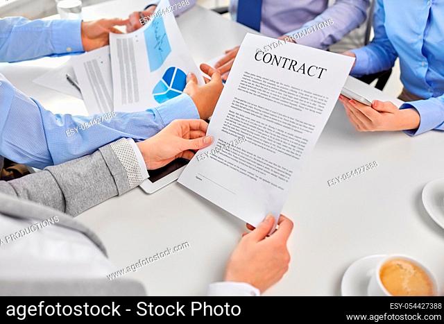 close up of business team with charts and contract