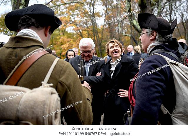 31 October 2019, US, Boston: Federal President Frank-Walter Steinmeier and his wife Elke Büdenbender watch a historical demonstration in the Minute Man National...