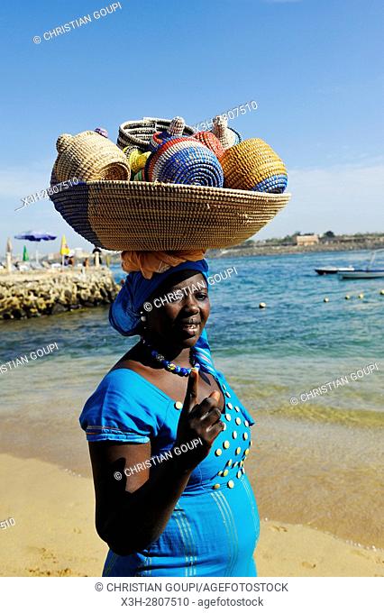 woman selling basketry on a beach at Ngor island, Dakar, Senegal, West Africa
