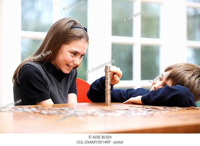 Children counting a pile of money