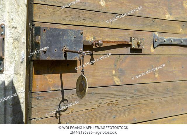 An old wooden door with an antique lock at La Bastide de Moustiers, a house converted to a hotel, in Moustiers-Sainte-Marie