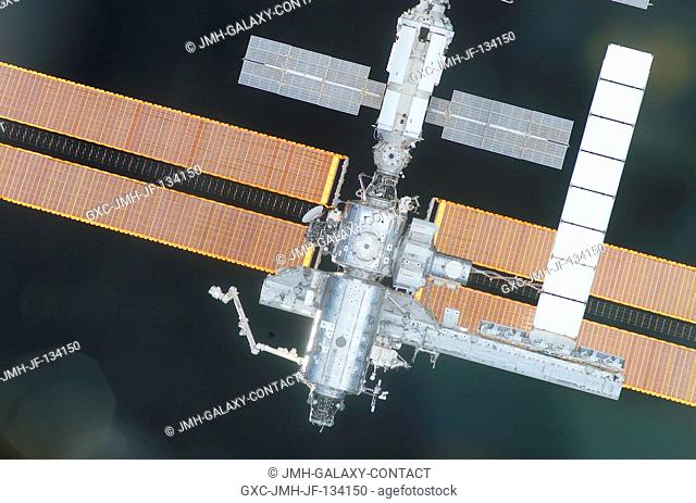 The International Space Station (ISS) is backdropped against the blackness of space as the Space Shuttle Endeavour quickly approaches the orbital outpost for a...