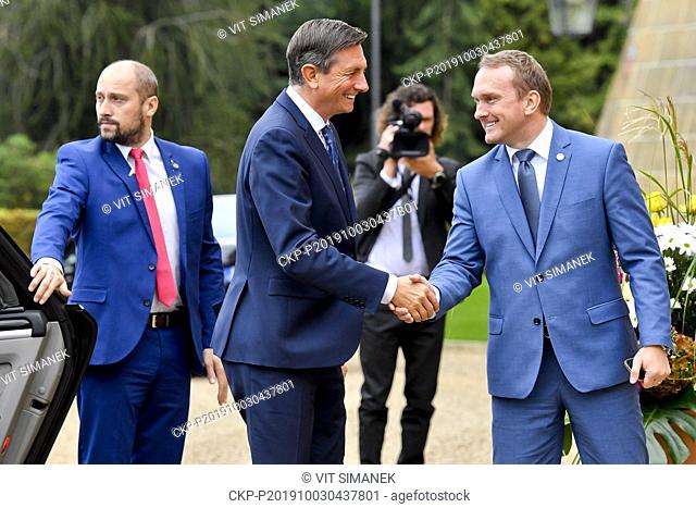 Head of the Presidential Office Protocol section Vladimir Krulis, right, welcomes Slovenian President Borut Pahor prior to the opening of plenary session of...