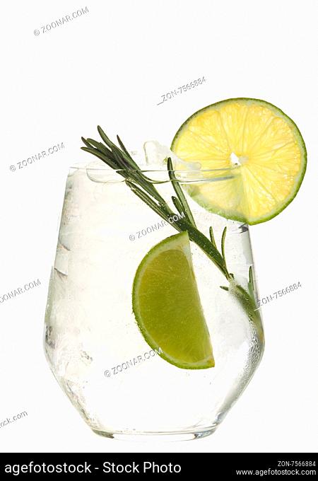 Glass with alcoholic drink with lime and ice isolated on white background