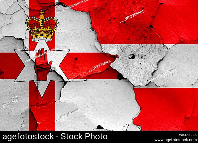 flags of Northern Ireland and Austria painted on cracked wall