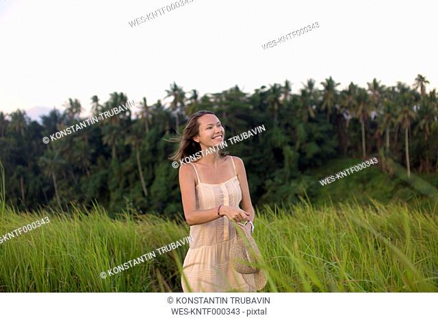 Indonesia, Bali, portrait of smiling woman in fields