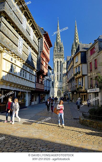 Cathedral of Saint Corentin seen beyond shops on Rue Kereon in the mediaeval city centre of Quimper, Finistere, Brittany, France