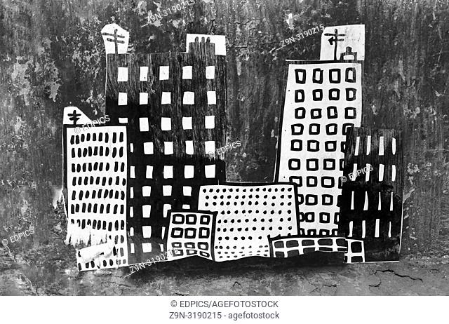 street art collage showing skyscrapers and smaller buildings at night, paris, ile de france, france