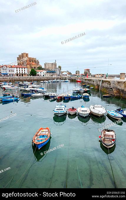 Castrourdiales, Spain - May 11, 2019: Cantabria village, Castrourdiales fishing port. Cityscape and boats in the sea