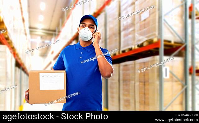 delivery man in mask with smartphone and parcel