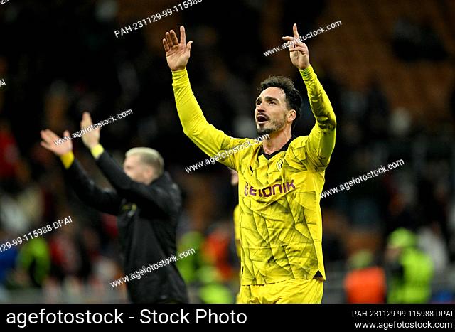 28 November 2023, Italy, Milán: Borussia Dortmund's Mats Hummels (right) and Marco Reus celebrate after the win over Milan in the Champions League group stage