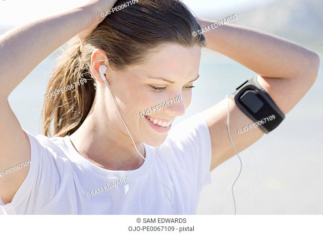 Woman runner listening to mp3 player