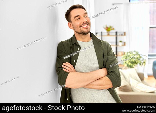 happy smiling man with crossed arms at home