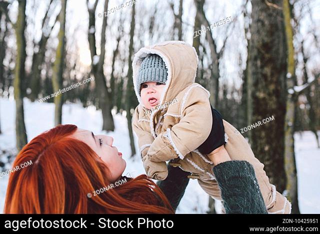 Mom and baby in the park in winter