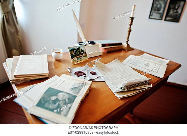 MUKACHEVO, UKRAINE - APRIL 11, 2016: Antique table writer with manuscripts feather pen and ink