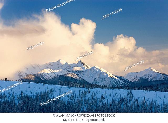 Clouds over the North Cascades glowing in the light of a winter evening, Manning Provincial Park British Columbia Canada