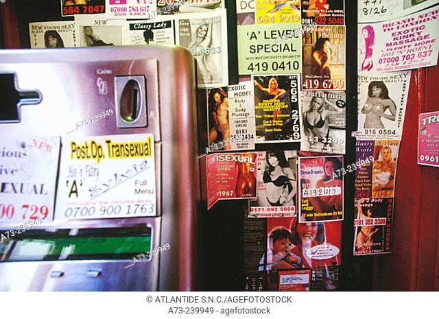 Sexual ads in a public telephone box in Soho. London. UK