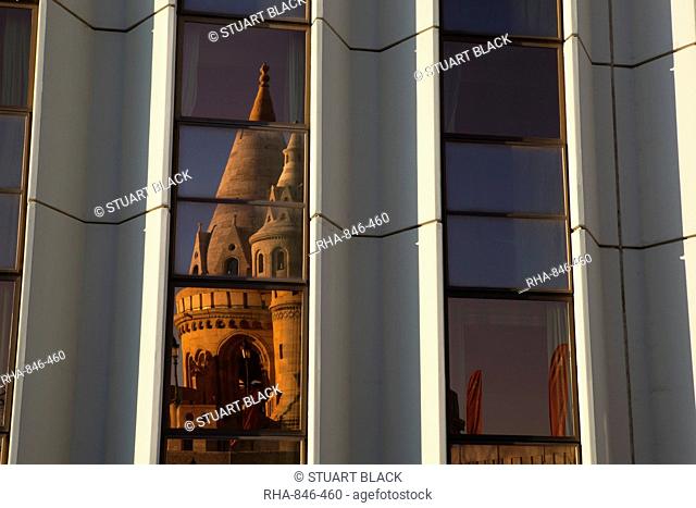 Fishermen's Bastion Halaszbastya reflected in windows of Hilton Hotel, Buda, Budapest, Hungary, Europe