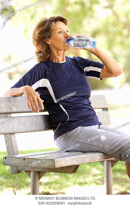 Senior Woman Resting After Exercise In Park