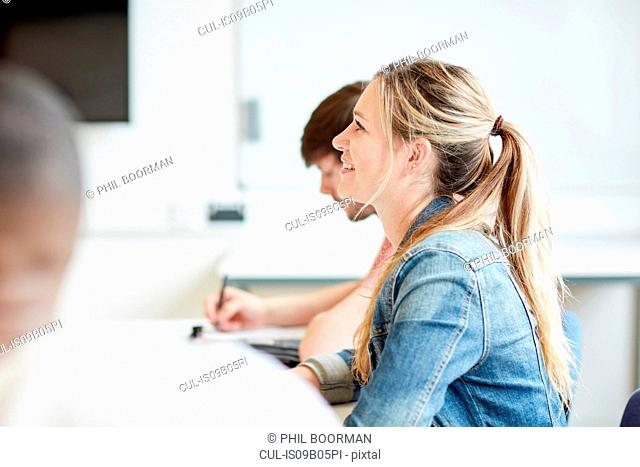 Female student listening in higher education college classroom