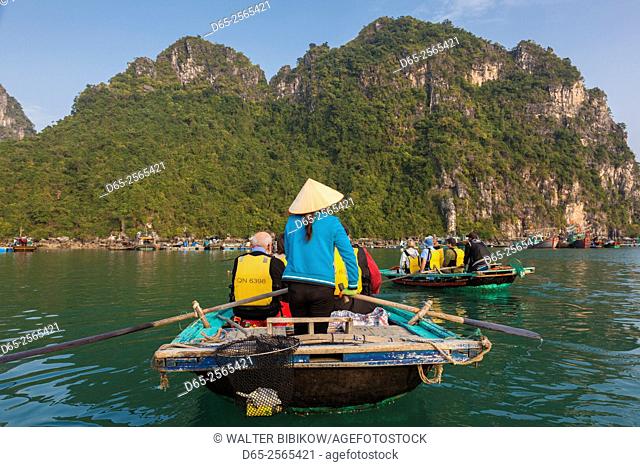 Vietnam, Halong Bay, floating fishing village by rowboat
