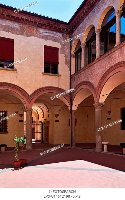 Renaissance courtyard of Palazzo Paleotti, with typical arched portico, windows arched and rectangular on first floor, and tiled pavimenti flooring, Bologna