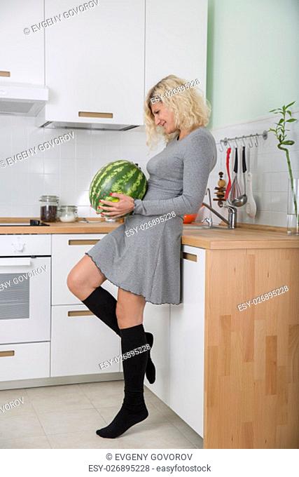 Blonde girl with curly hair with watermelon
