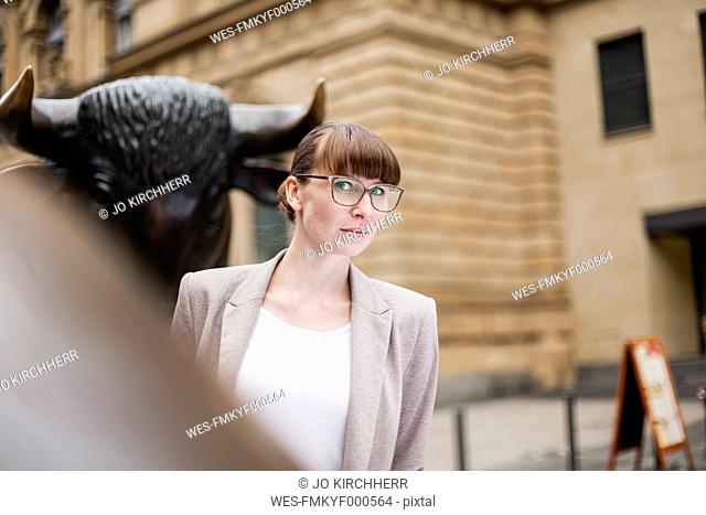 Germany, Hesse, Frankfurt, portrait of businesswoman in front of stock market