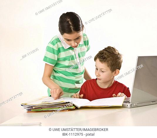 Girl helping a boy with his homework