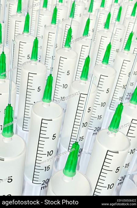 Many medical syringes filled with vaccine in portrait format