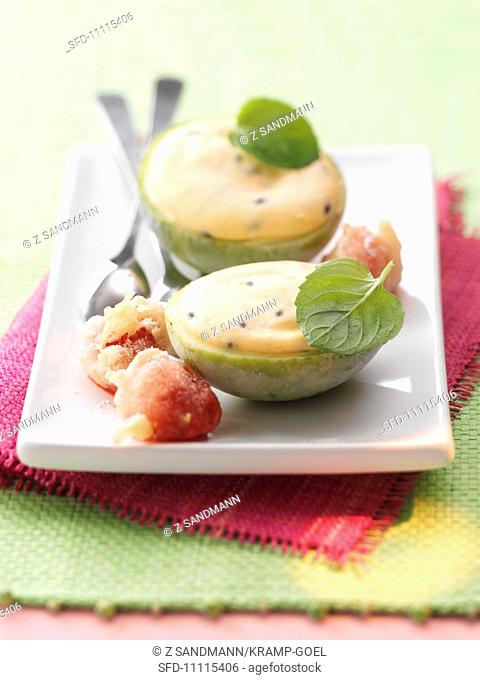 Passion fruit parfait with baked strawberries and mint leaves