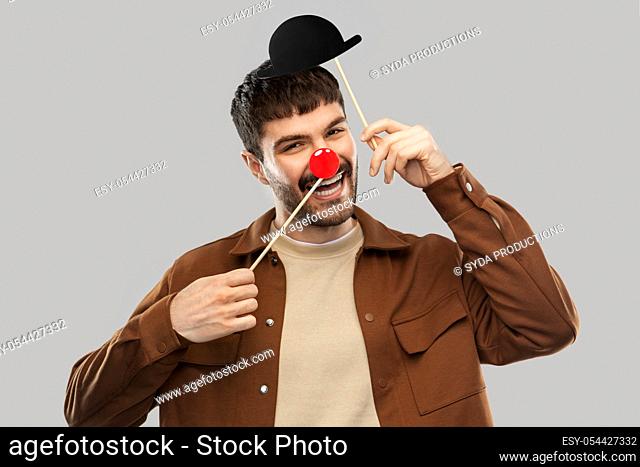 smiling man with bowler hat and red clown nose