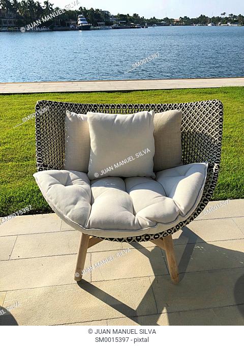 Chair in patio in fron of water, Key Biscayne, Florida, USA