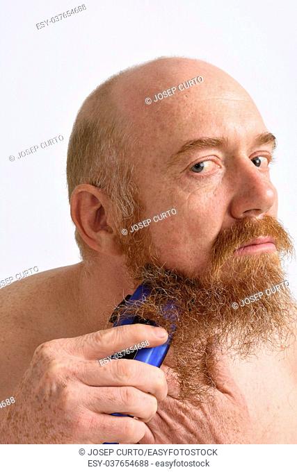 redheaded man shaving his beard