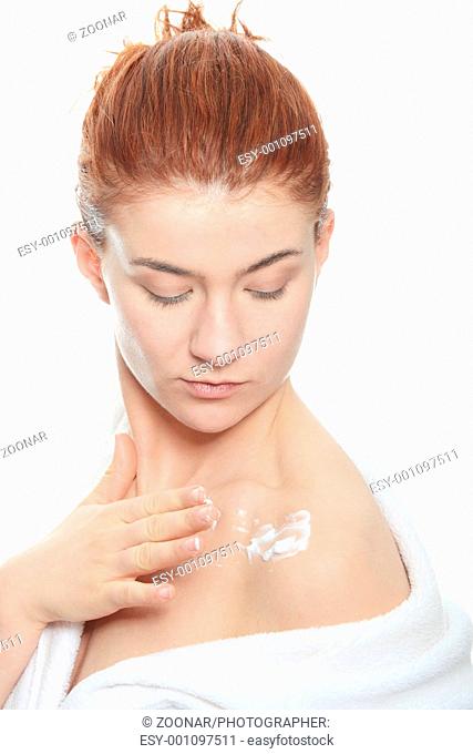 Woman applying moisturizer cream