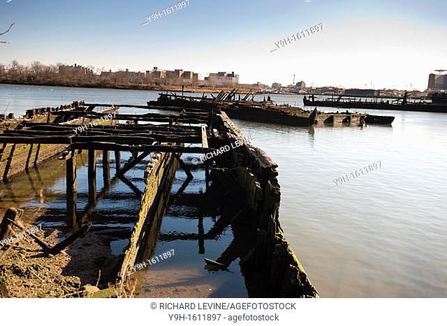 The burnt remains of derelict boats and piers litter the shoreline of Coney Island Creek in Brooklyn in New York The little used waterway off of Bensonhurst...