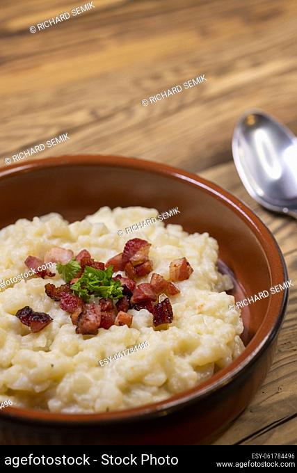 Slovakian halusky served with sheep cheese and roasted bacon
