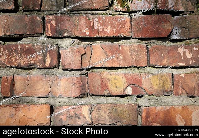 red brick old wall with cement, fragment of architecture, close up