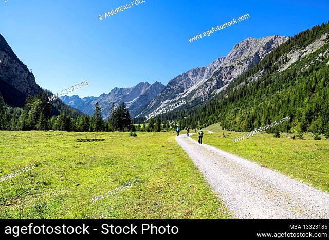 Cyclists and hikers on the move in the Karwendel Valley on a sunny summer day. Karwendel, Tyrol, Austria
