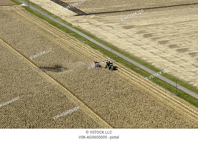 Aerial shot of farmer harvesting crops