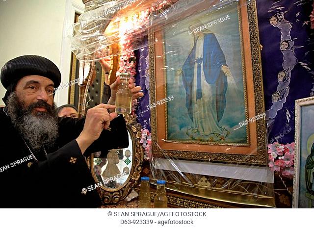 Egypt. Coptic Orthodox Bishop Tadros of Port Said, with a famous icon of Saint Mary which oozes holy oil, a phenomena which starts in mid February and continues...