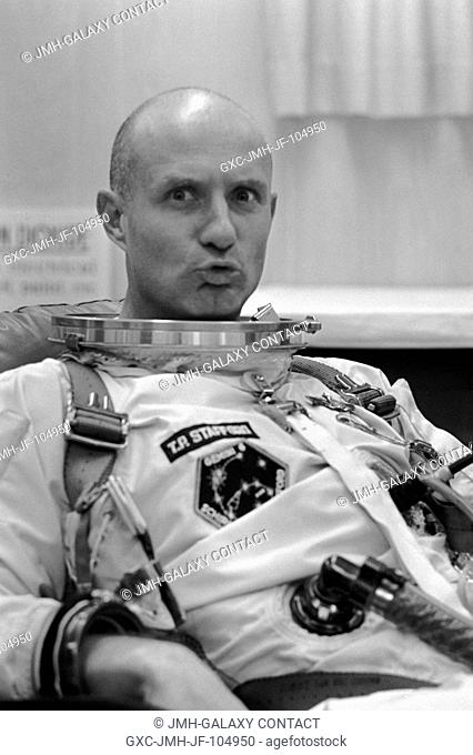 Astronaut Thomas P. Stafford, pilot, makes a facial gesture at the camera while suiting up in Launch Complex 16 trailer during Gemini-6 prelaunch countdown