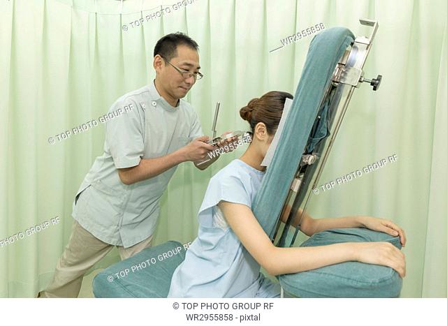 Doctor Manipulating the Back Neck of A Woman